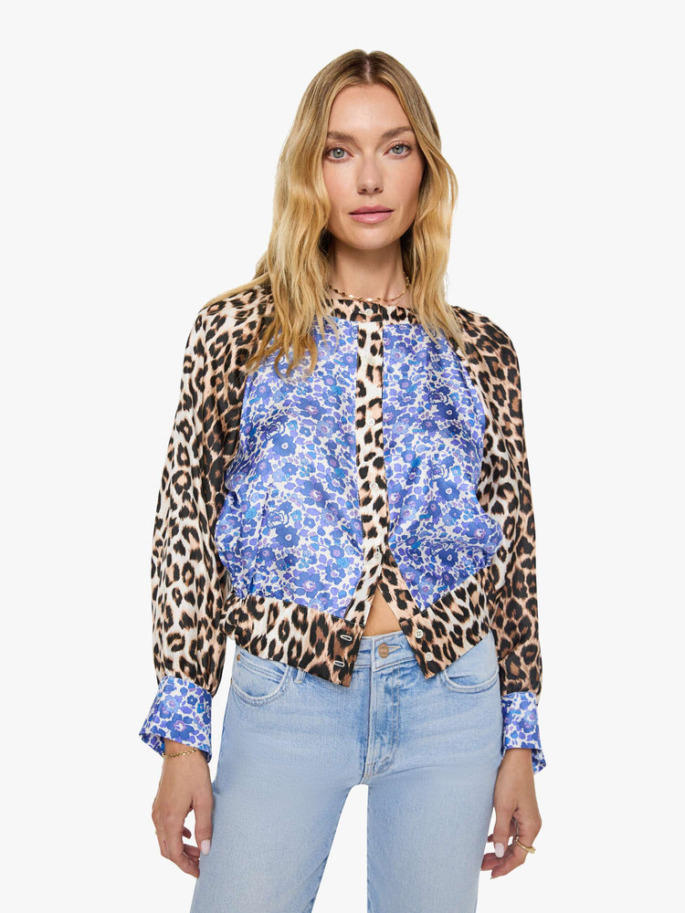 Front view of a woman in blue and white floral print with cheetah print trim and sleeves shirt with a crewneck, long balloon sleeves and a slightly cropped fit.