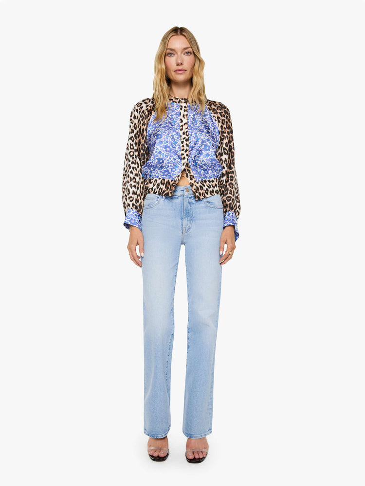 Full body view of a woman in blue and white floral print with cheetah print trim and sleeves shirt with a crewneck, long balloon sleeves and a slightly cropped fit.