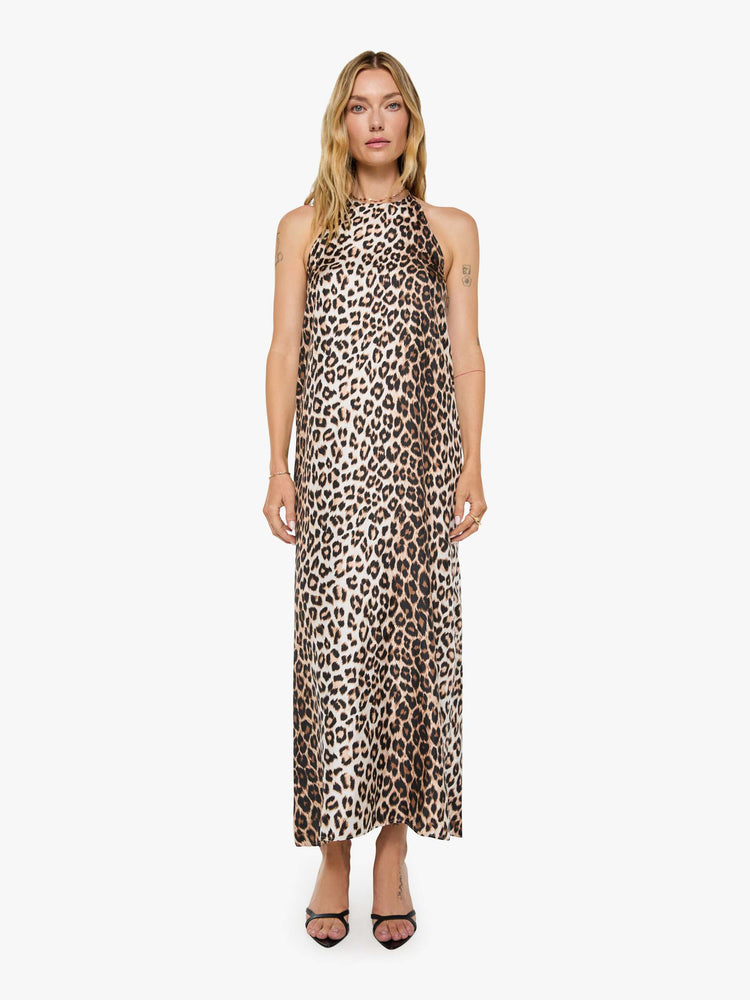 Front view of a woman in cheetah print dress with a halter neck, ankle-length hem and a loose, flowy fit.
