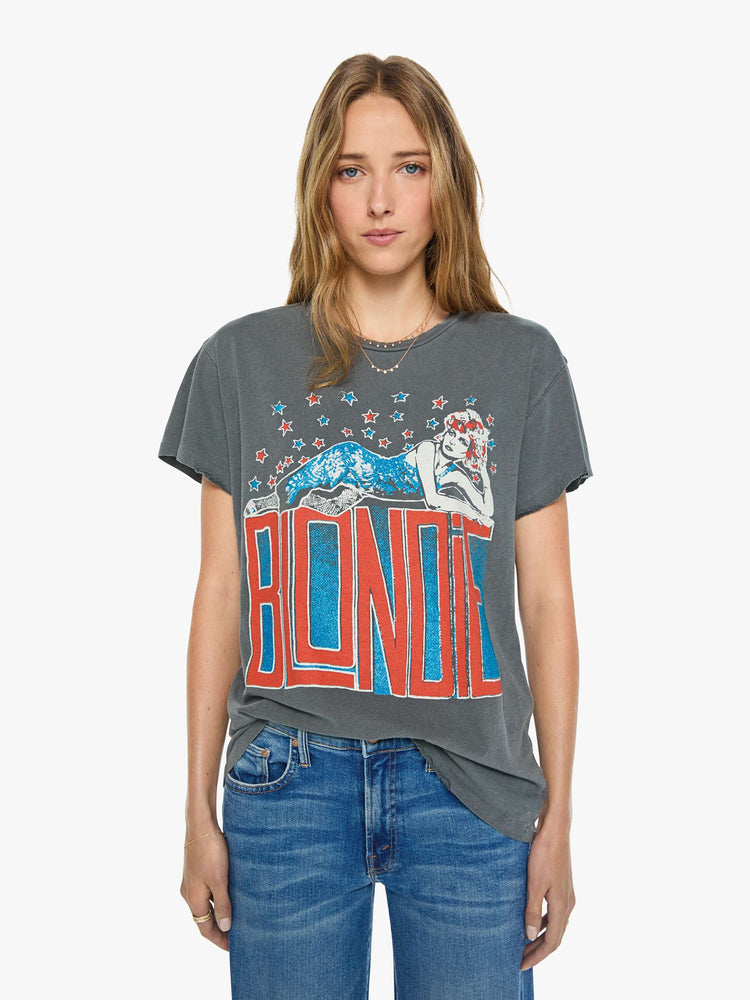 Front view of a woman in a faded black  tee pays homage to Blondie with a colorful graphic and the band's name in red on the front.