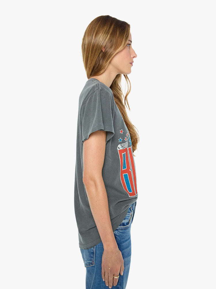 Side view of a woman in a faded black  tee pays homage to Blondie with a colorful graphic and the band's name in red on the front.