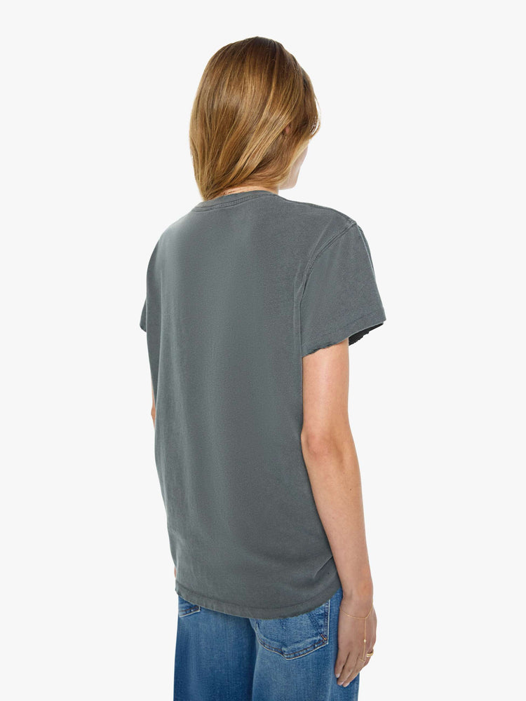 Back view of a woman in a faded black  tee pays homage to Blondie with a colorful graphic and the band's name in red on the front.
