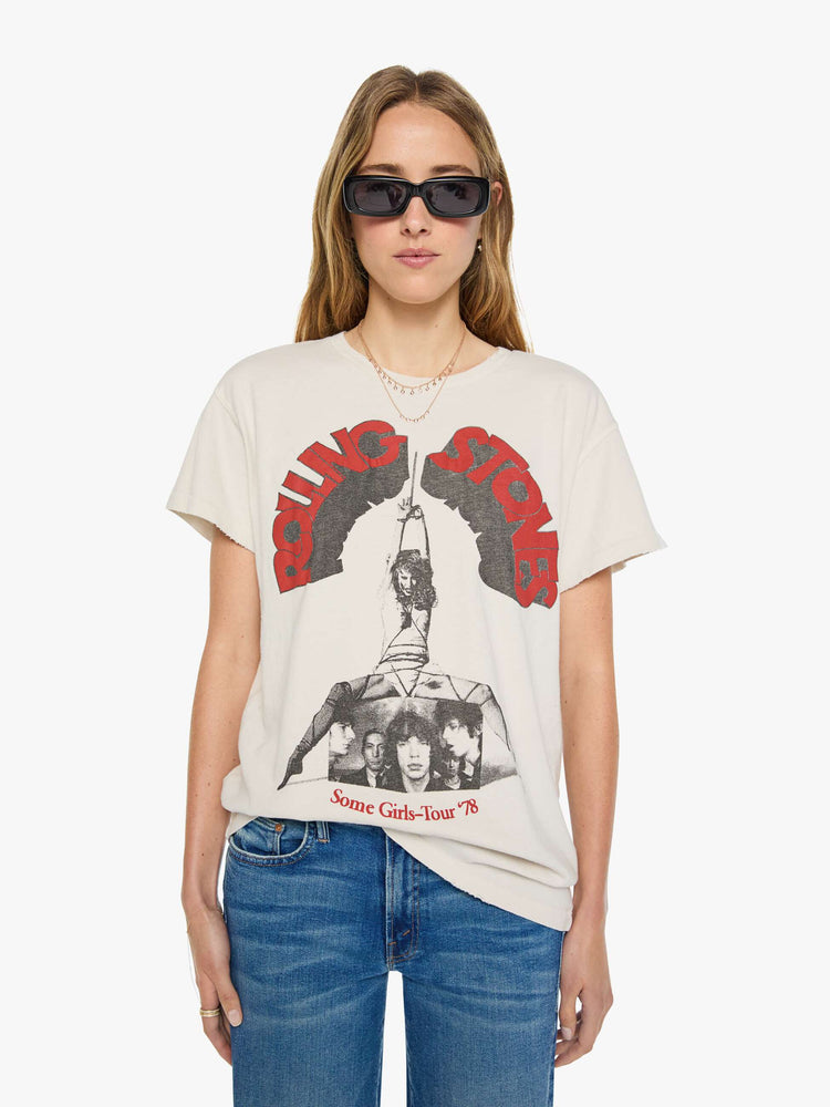 Front view of a woman in a vintage white tee pays homage to The Rolling Stones' 1978 tour with a black and white graphic and the band's name in red and black on the front.