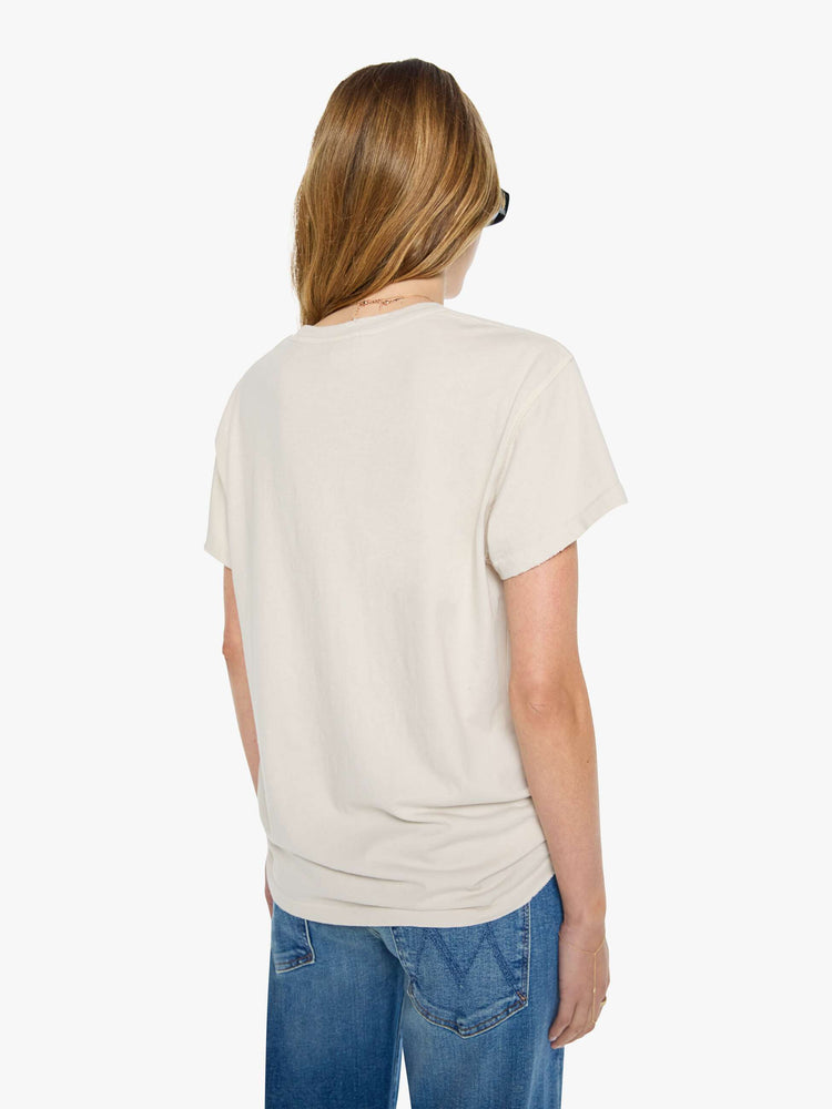 Back view of a woman in a vintage white tee pays homage to The Rolling Stones' 1978 tour with a black and white graphic and the band's name in red and black on the front.