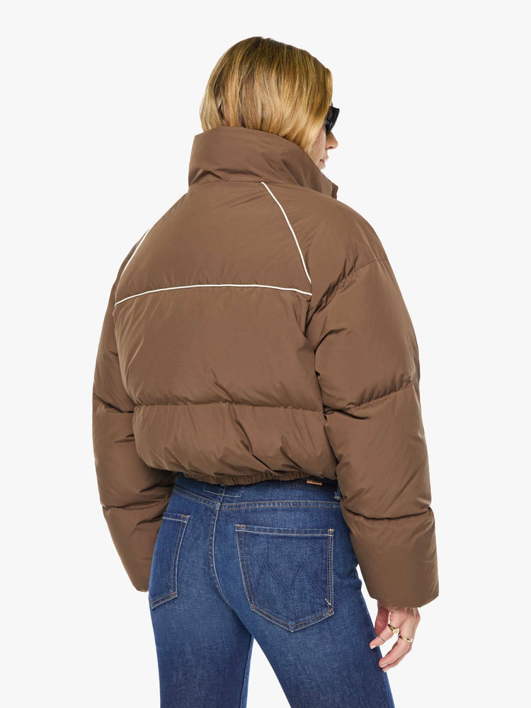 Back view of a woman in brown with cream piping jacket has a high neck, front zip pockets, elastic hems and a cropped fit.