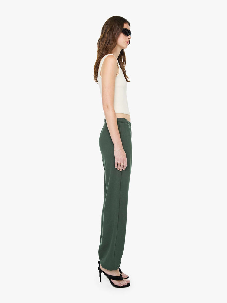 Side view of a woman in forest green sweatpants are designed with an elastic waistband and hems, slit pockets and a loose, comfortable fit.