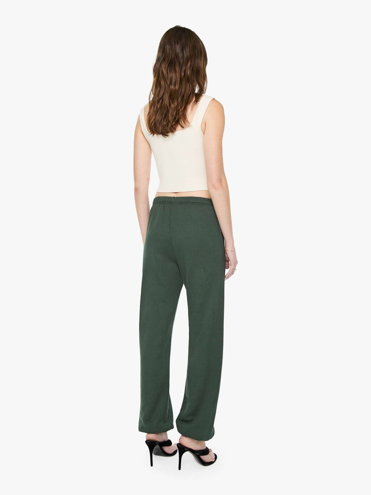 Back view of a woman in forest green sweatpants are designed with an elastic waistband and hems, slit pockets and a loose, comfortable fit.
