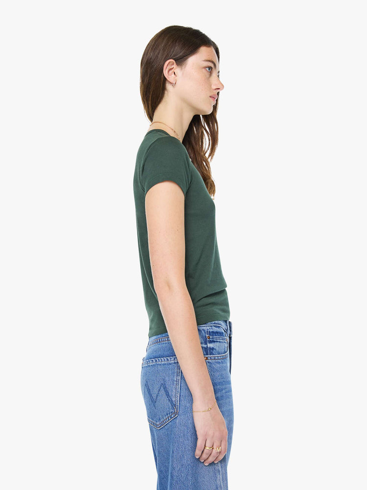 Side view of a woman in a forest green crewneck tee is designed with short sleeves and a narrow fit.