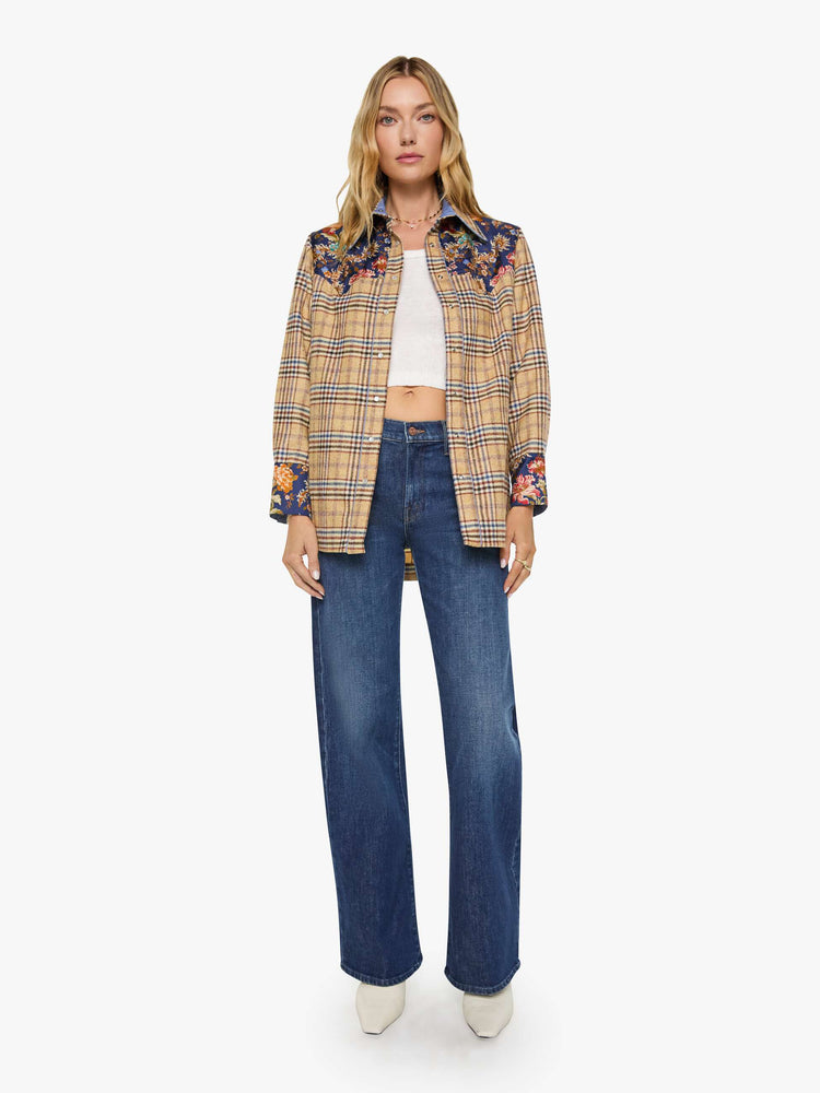 Full body view of a woman in a jacket is made from 100% wool in yellow and blue plaid with floral-print panels at the chest and wrists, and features a collared neck and slightly dropped shoulders.