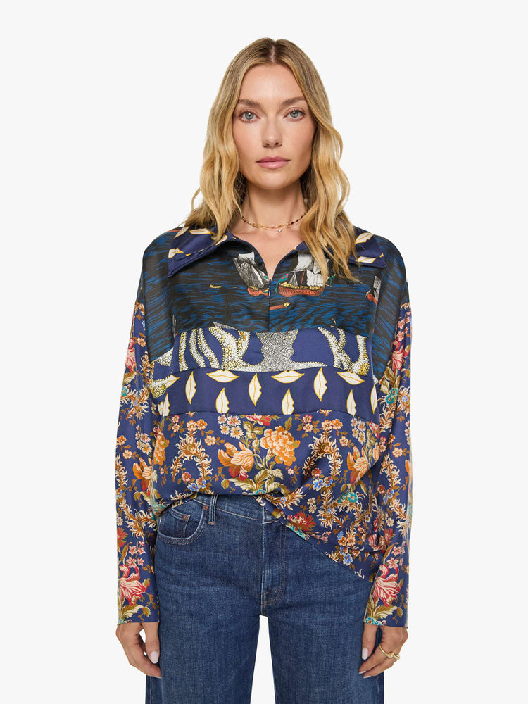 Front view of a woman in mix of graphic prints blouse with a collared V-neck, dropped shoulders, extra-long sleeves and a loose fit.