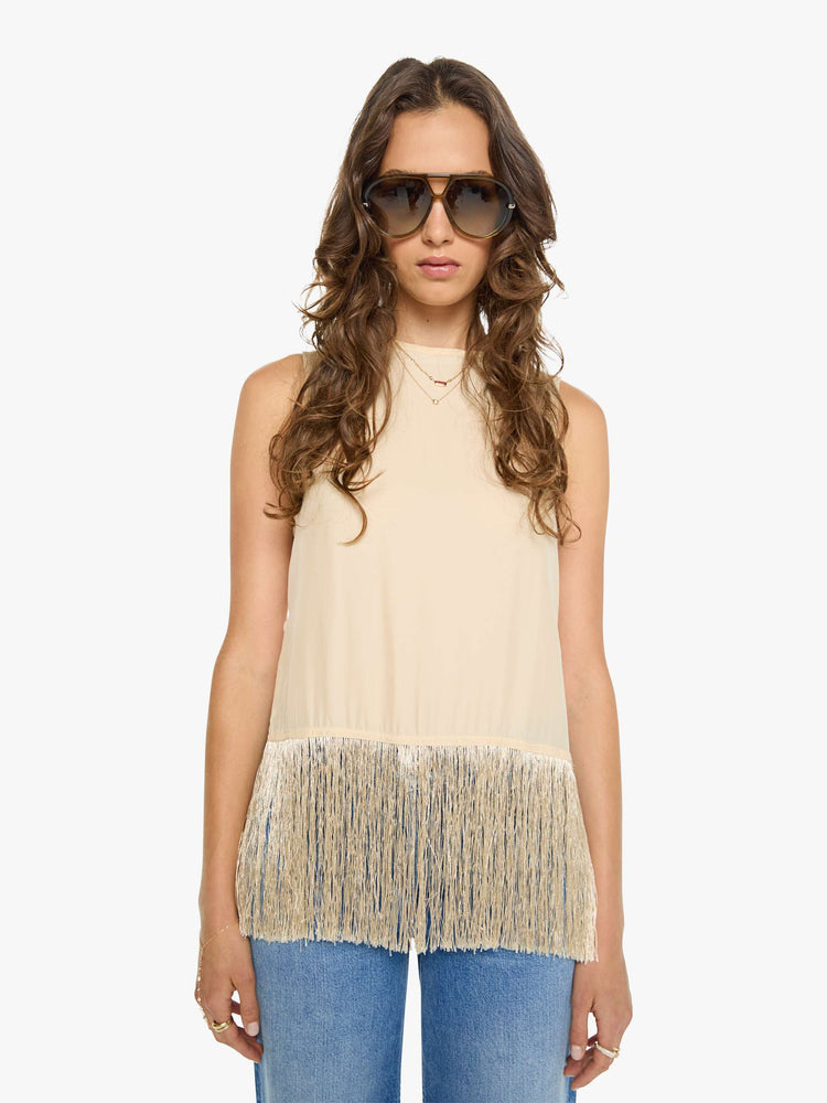 Front view of a woman in a top has a crew neck, side slits and a loose, cropped fit with long fringe at the hem.