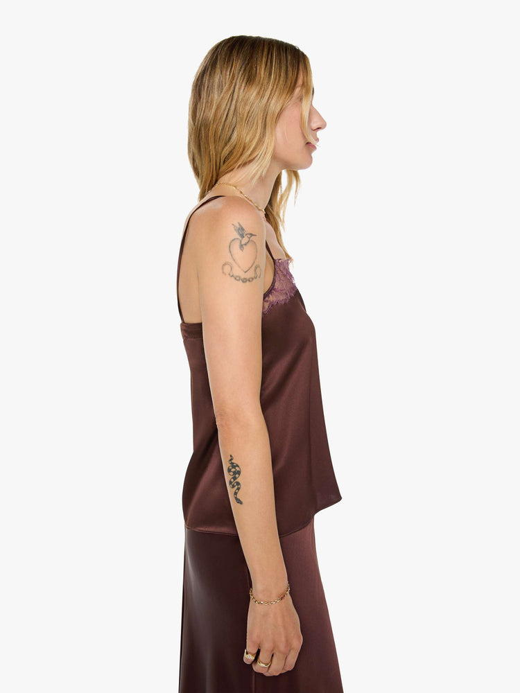 Back view of a woman in a silk in a chocolate brown with lace trim, the cami is designed with a square neck, thin spaghetti straps and a loose, boxy fit.