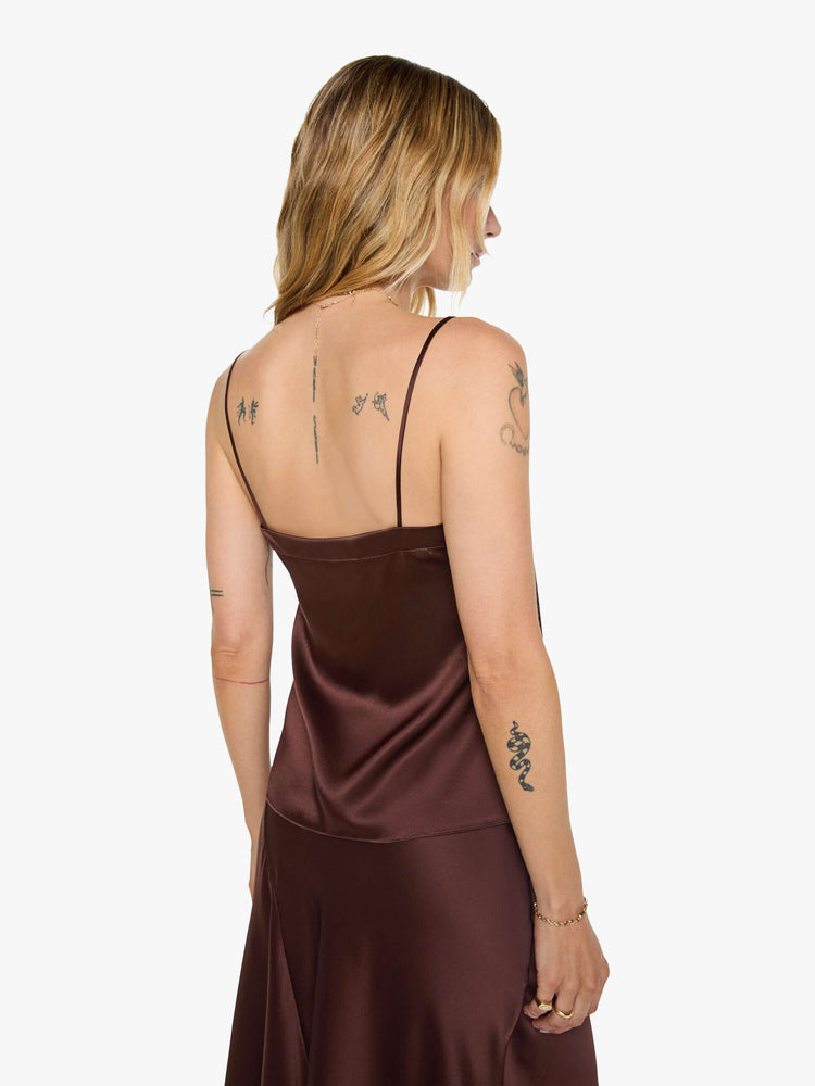 Back view of a woman in a silk in a chocolate brown with lace trim, the cami is designed with a square neck, thin spaghetti straps and a loose, boxy fit.