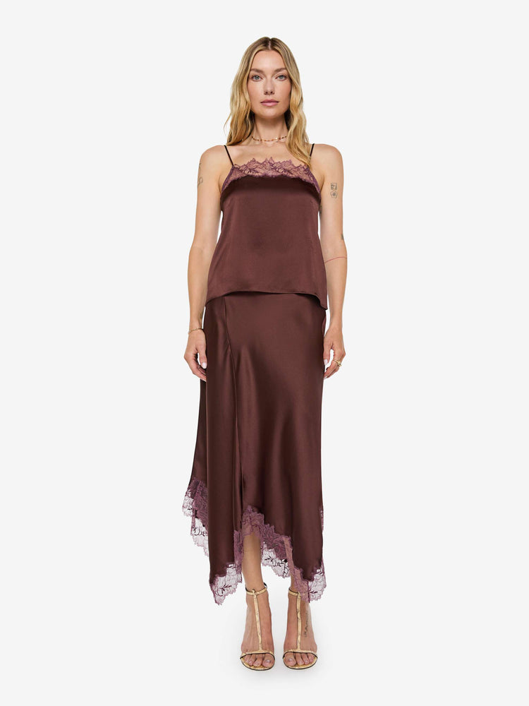 Full body view of a woman in a silk in a chocolate brown with lace trim, the cami is designed with a square neck, thin spaghetti straps and a loose, boxy fit.