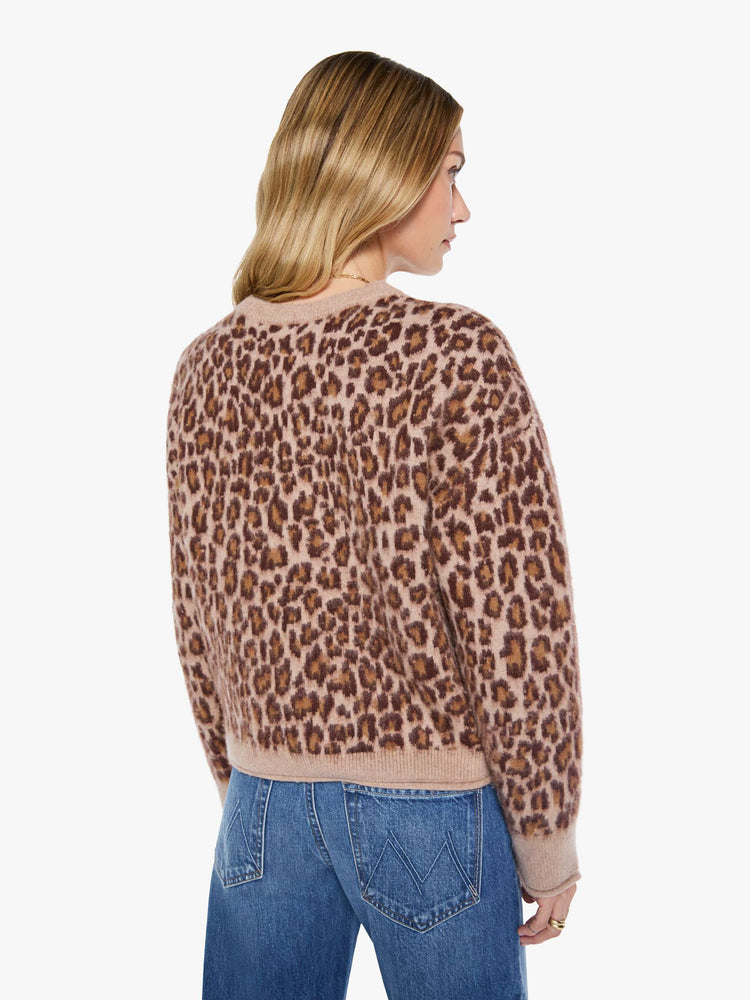 Back view of a woman in a cheetah print sweater designed with drop shoulders, ribbed hems and a slouchy fit.
