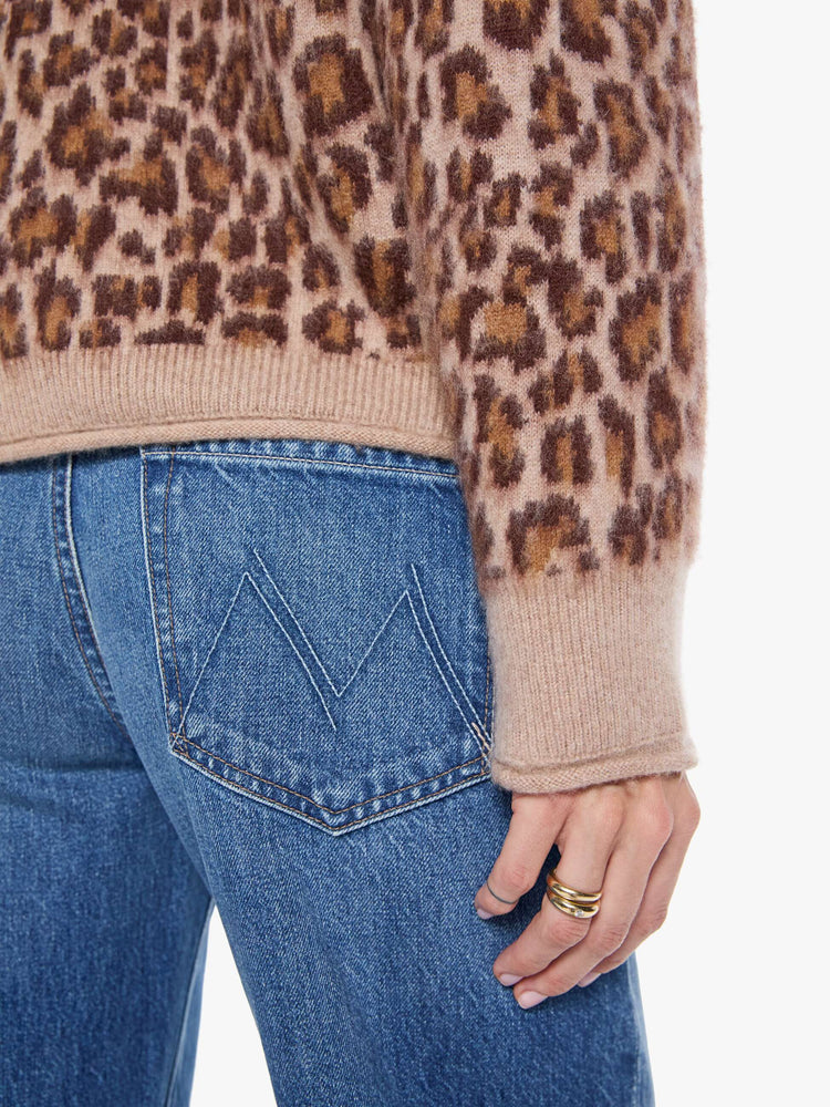 Close up view of a woman in a cheetah print sweater designed with drop shoulders, ribbed hems and a slouchy fit.