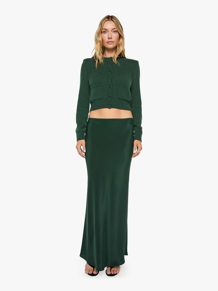Full body view of a woman in a low-rise maxi skirt is designed with a straight fit and a flowy, floor-length hem.