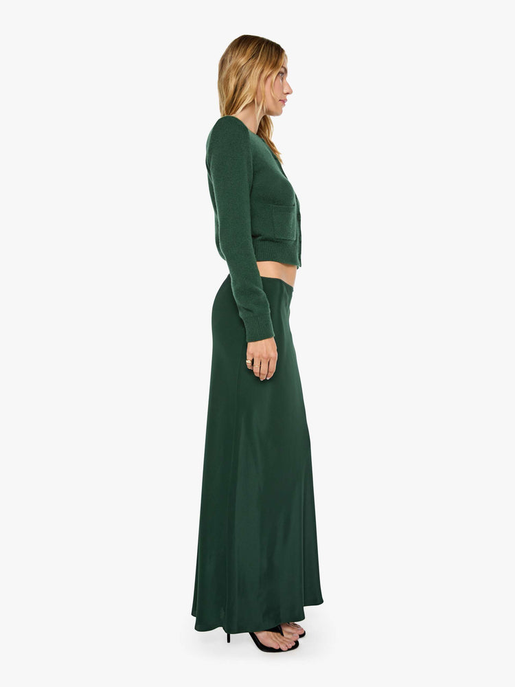 Side view of a woman in a low-rise maxi skirt is designed with a straight fit and a flowy, floor-length hem.