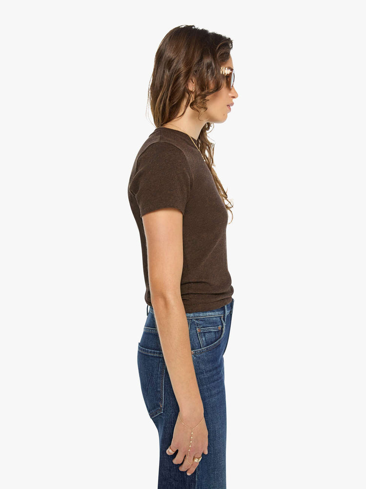 Side view of a woman in a brown baby tee from SPRWMN with a hip-length hem, short sleeves and a semi-fitted shape.
