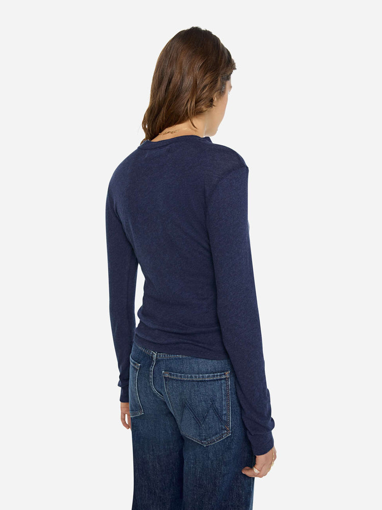 Back view of a woman in a navy baby tee with a hip-length hem, long sleeves and a semi-fitted shape.