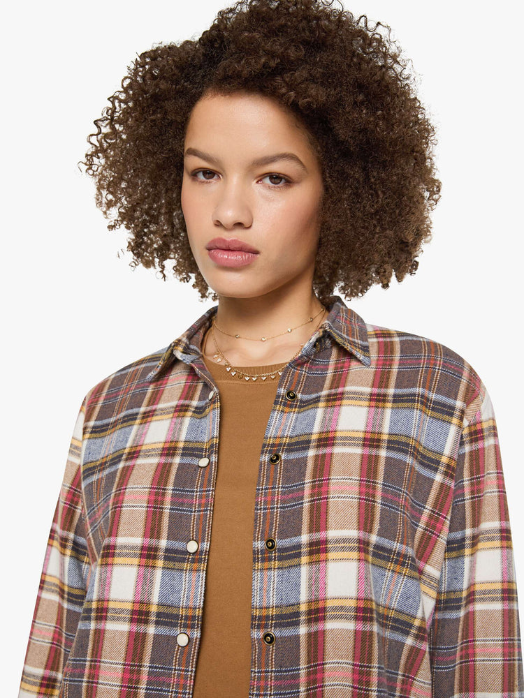 Front close up view of a womens plaid button up shirt featuring neutral tones.