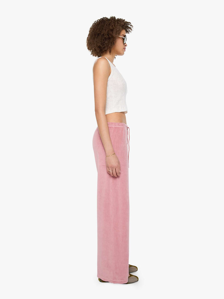 Side view of a womens velour sweatpant featuring a wide leg and rope drawstring.