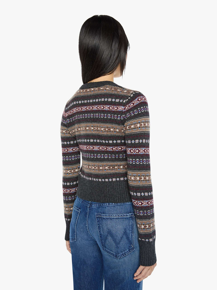 Back view of a woman in a black with horizontal knit details cardigan designed with a crewneck, long sleeves, ribbed hems and a cropped fit.