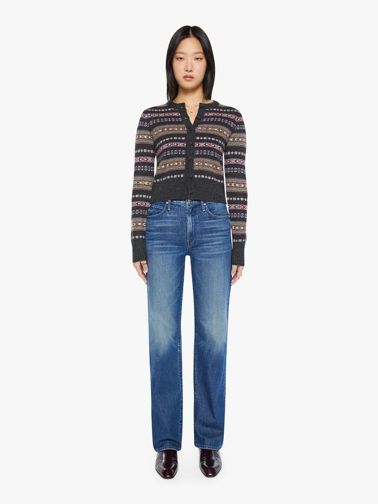Full body view of a woman in a black with horizontal knit details cardigan designed with a crewneck, long sleeves, ribbed hems and a cropped fit.
