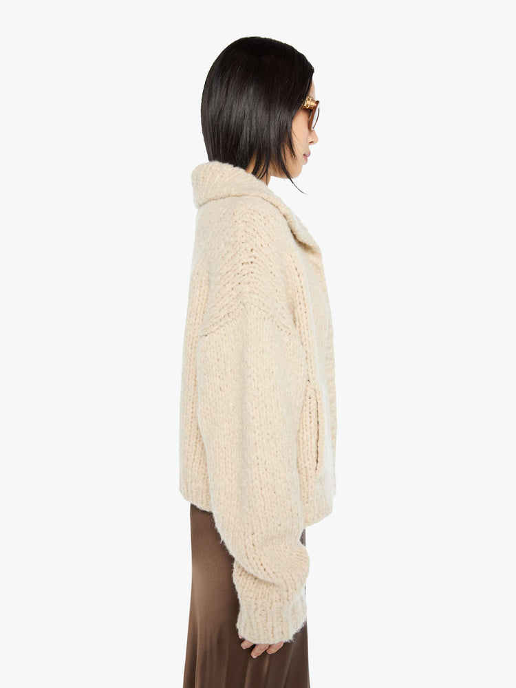 Side view of a woman in a jacket designed with a collared neck, drop shoulders, ribbed hems and a boxy fit.
