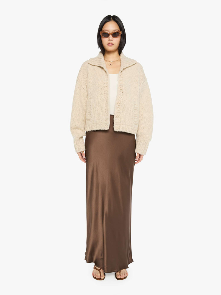 Full body view of a woman in a jacket designed with a collared neck, drop shoulders, ribbed hems and a boxy fit.