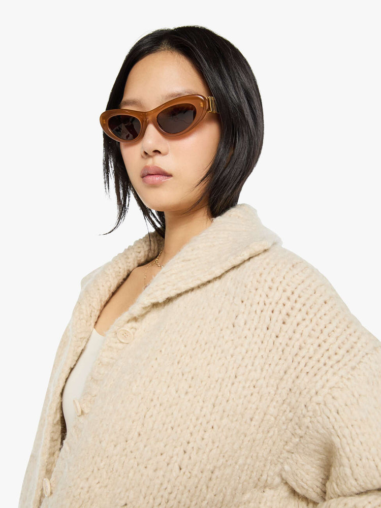 Close up view of a woman in a jacket designed with a collared neck, drop shoulders, ribbed hems and a boxy fit.