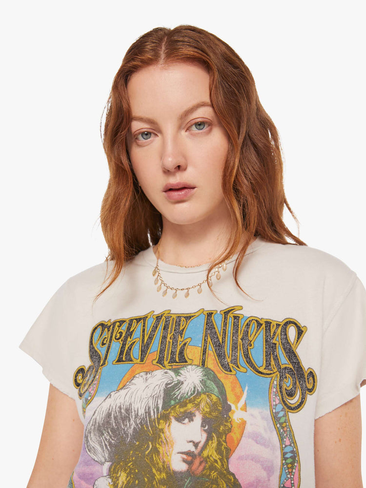 Close up view women's white stevie nicks graphic tee with multicolor detail featuring yellow, blue, black, pink, purple and black. 