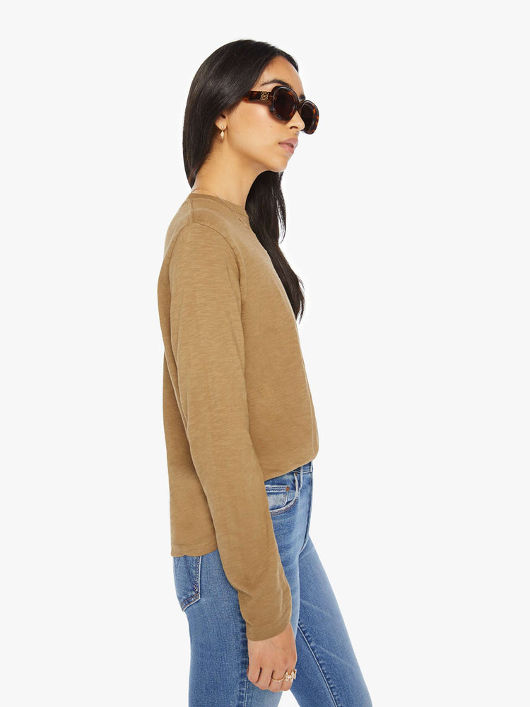Side view of a woman olive long-sleeve crewneck with a slightly boxy shape.