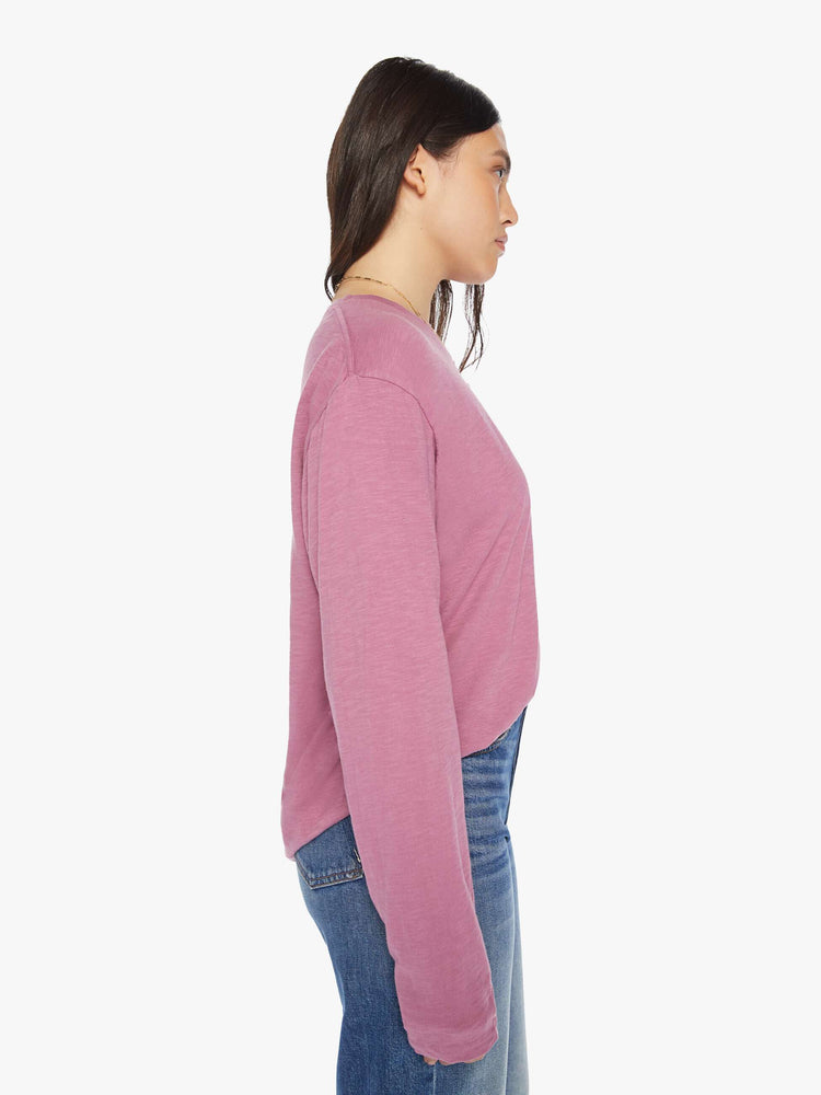Side view of a woman plum long-sleeve crewneck with a slightly boxy shape.