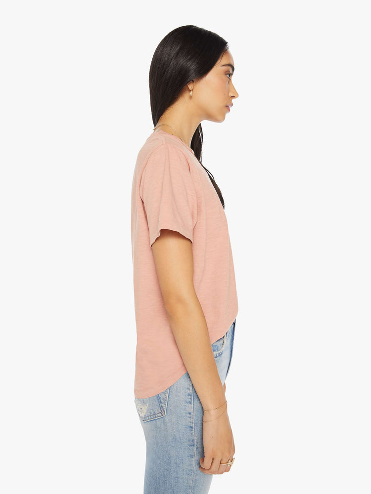 Side view of a woman crewneck in a faded peach tee with a slightly boxy shape.