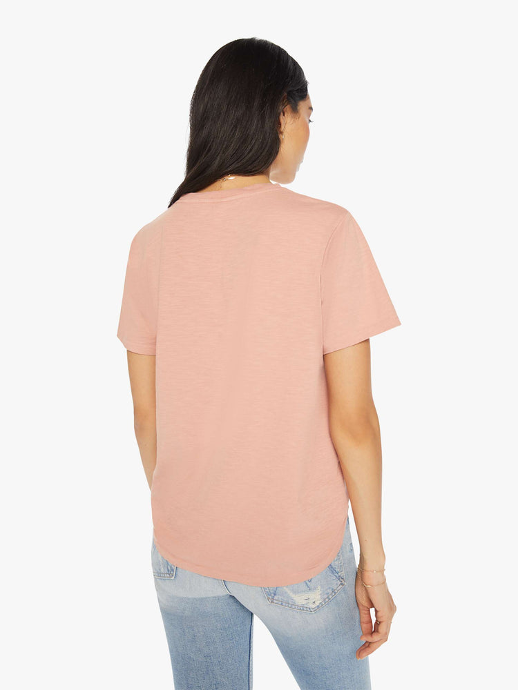 Back view of a woman crewneck in a faded peach tee with a slightly boxy shape.