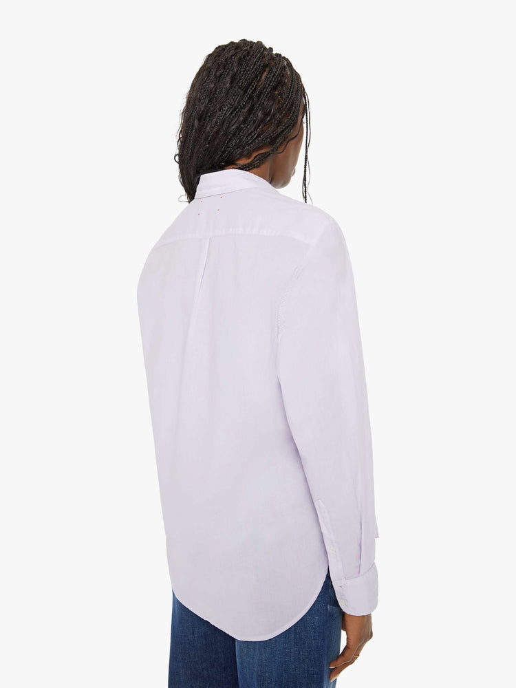 Back view of a woman light-blue button-down long sleeve shirt is light and airy with a loose fit.