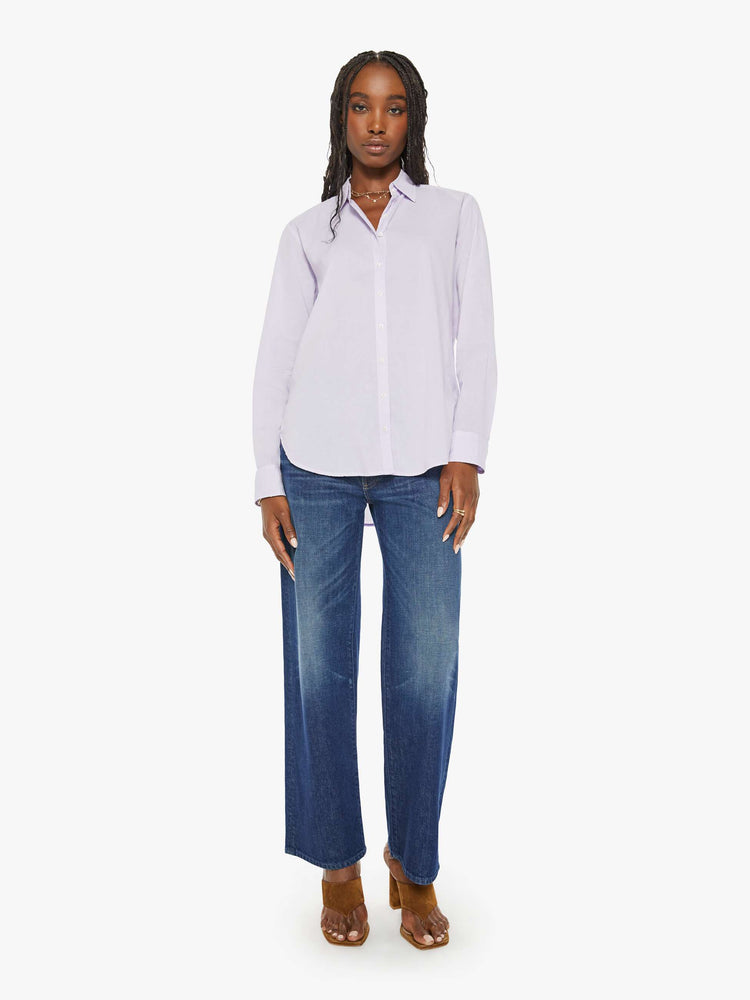 Full body view of a woman light-blue button-down long sleeve shirt is light and airy with a loose fit.