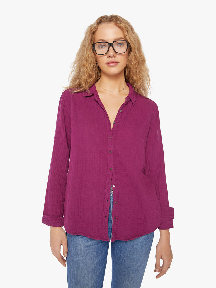 Front view of a woman plum button down long sleeve shirt with a Vneck and curved hem.