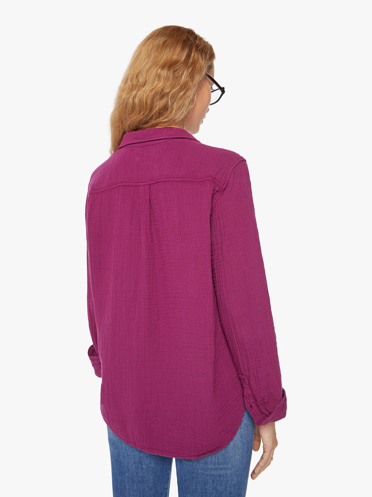 Back view of a woman plum button down long sleeve shirt with a Vneck and curved hem.