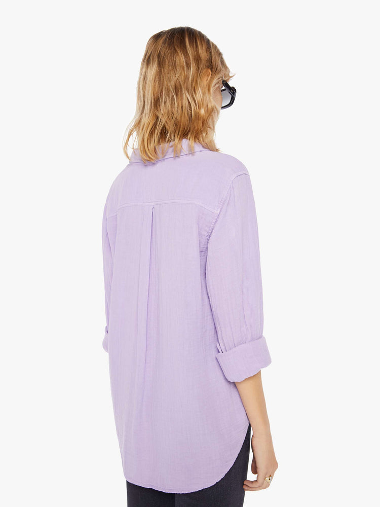 Back view of a womens light purple button down long sleeve shirt with a curved hem.