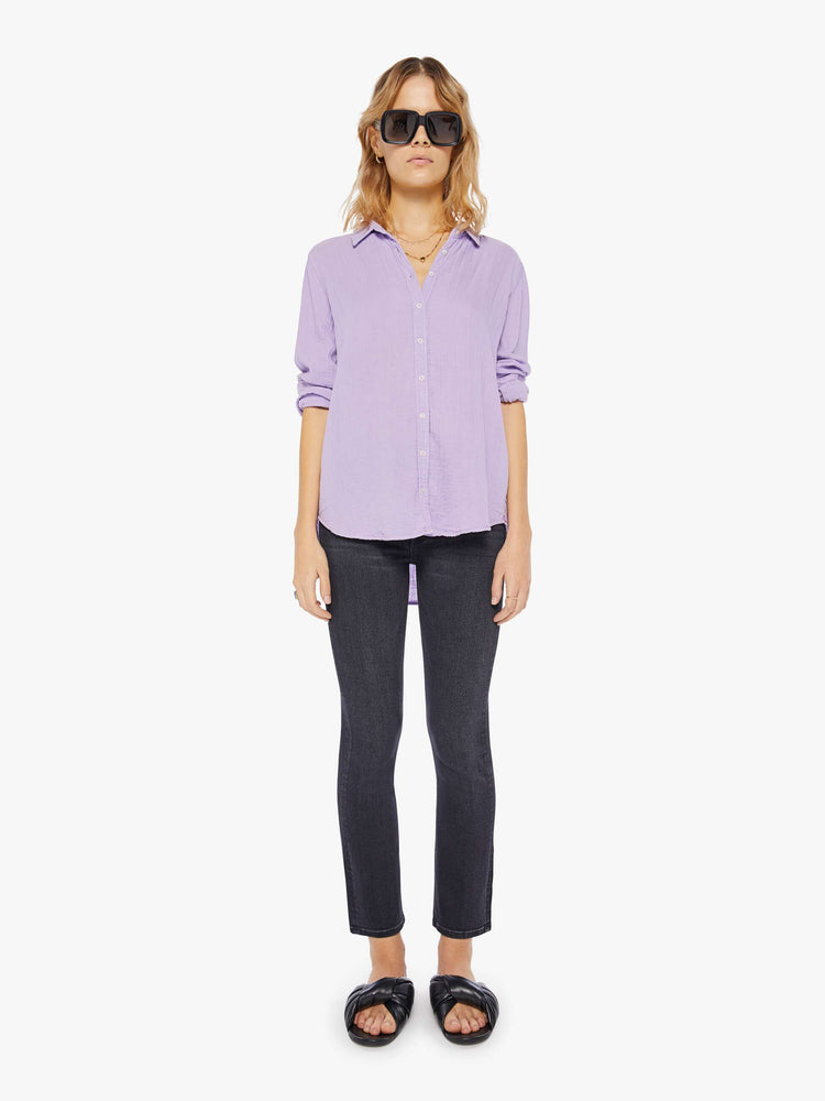 Front full body view of a womens light purple button down long sleeve shirt with a curved hem.