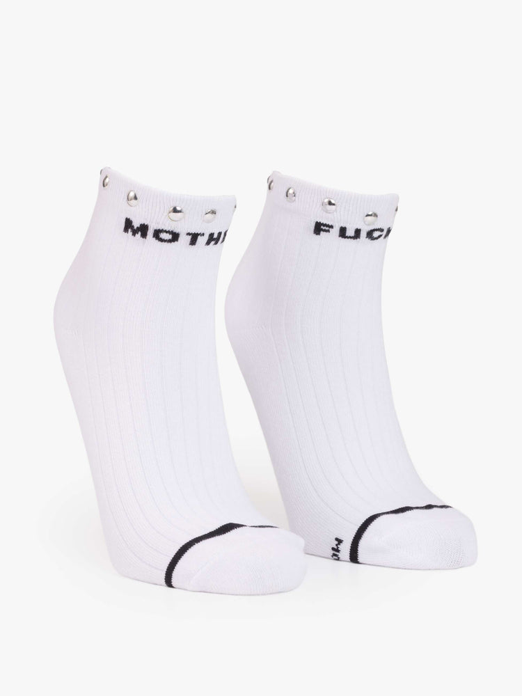Flat view of a MOTHER's classic black and white tube sock now in an ankle style with metal studs along the hem.