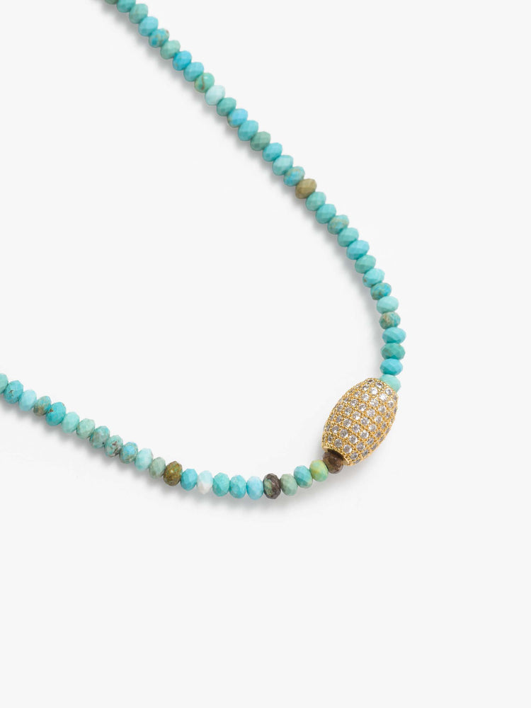 Swatch view of a beaded necklace with turquoise and gold beads and a gold-plated oval charm.