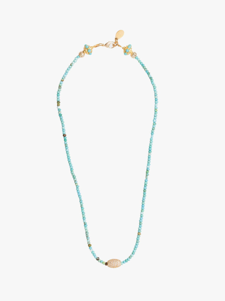 Full view of a beaded necklace with turquoise and gold beads and a gold-plated oval charm.