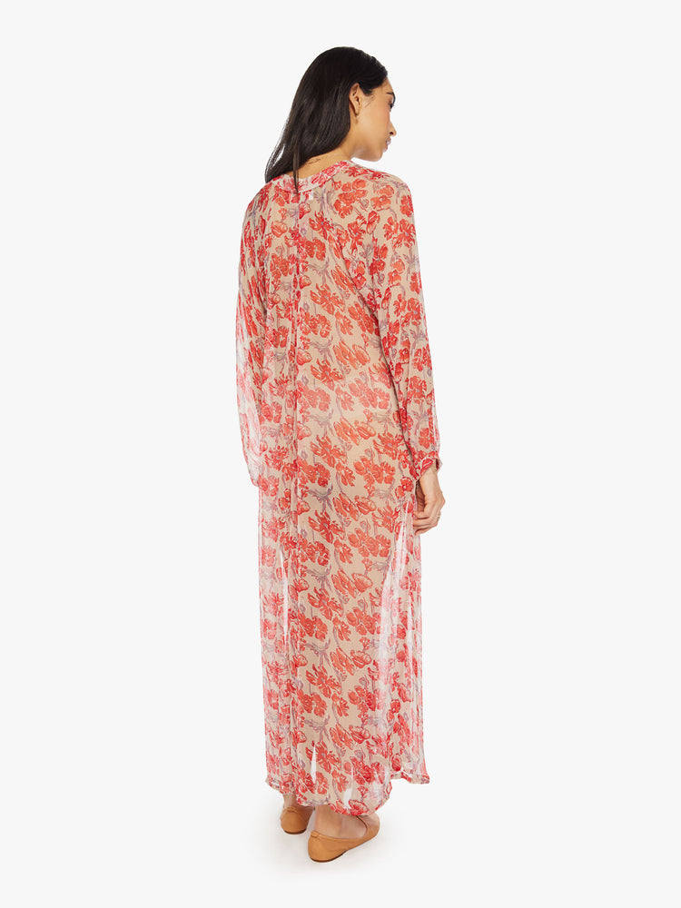 Back view of a woman sheer nude and red watercolor floral print maxi dress with designed with voluminous sleeves and has an A-line cut.