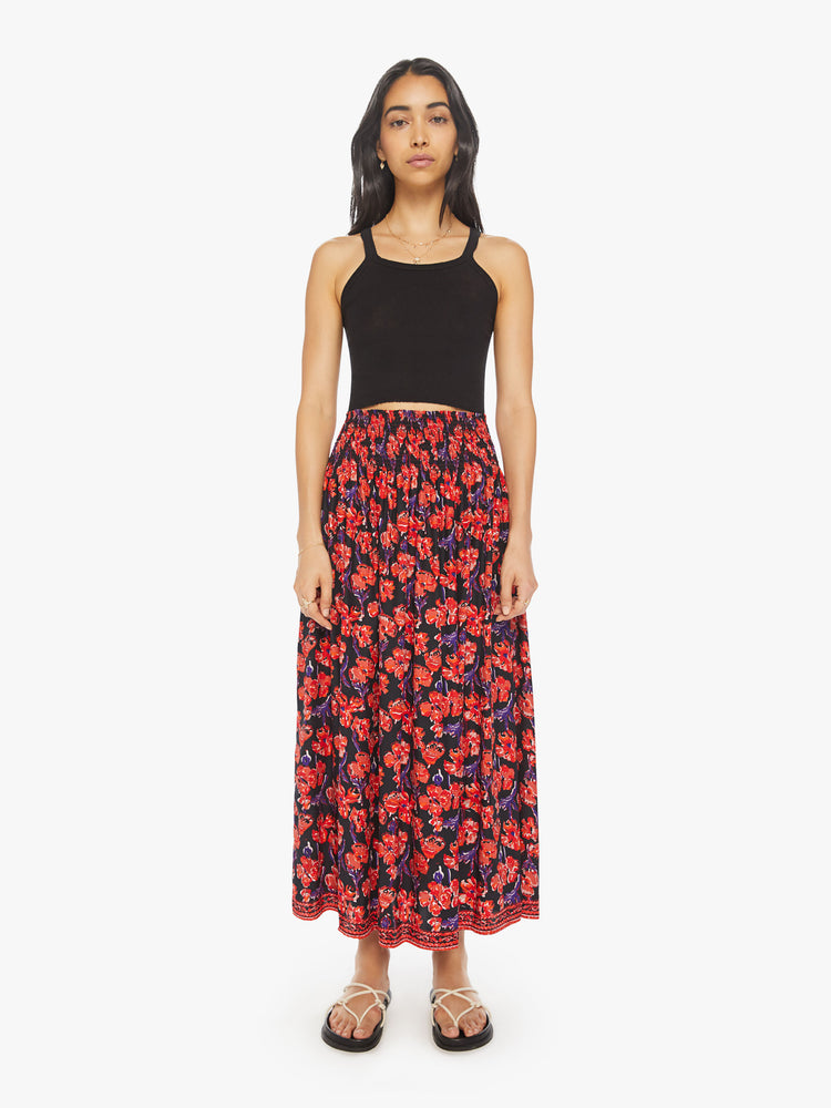 Front view of a woman black/red watercolor floral print with a smocked waistband and a loose, flowy fit.