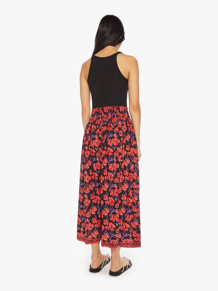 Back view of a woman black/red watercolor floral print with a smocked waistband and a loose, flowy fit.