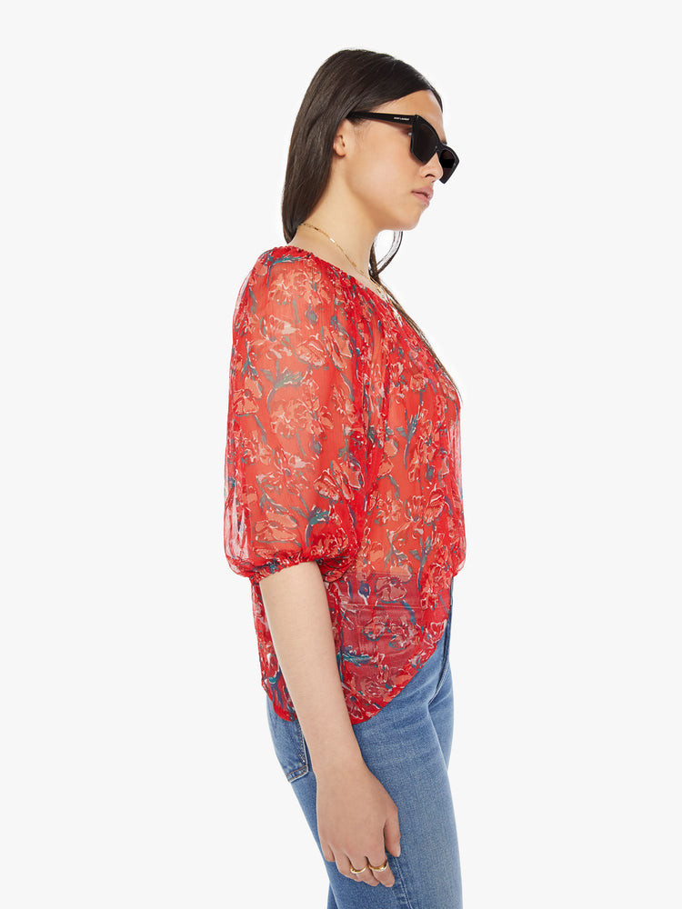Side view of a woman colorful floral print with a boat neck,3/4-length balloon sleeves and a flowy fit.