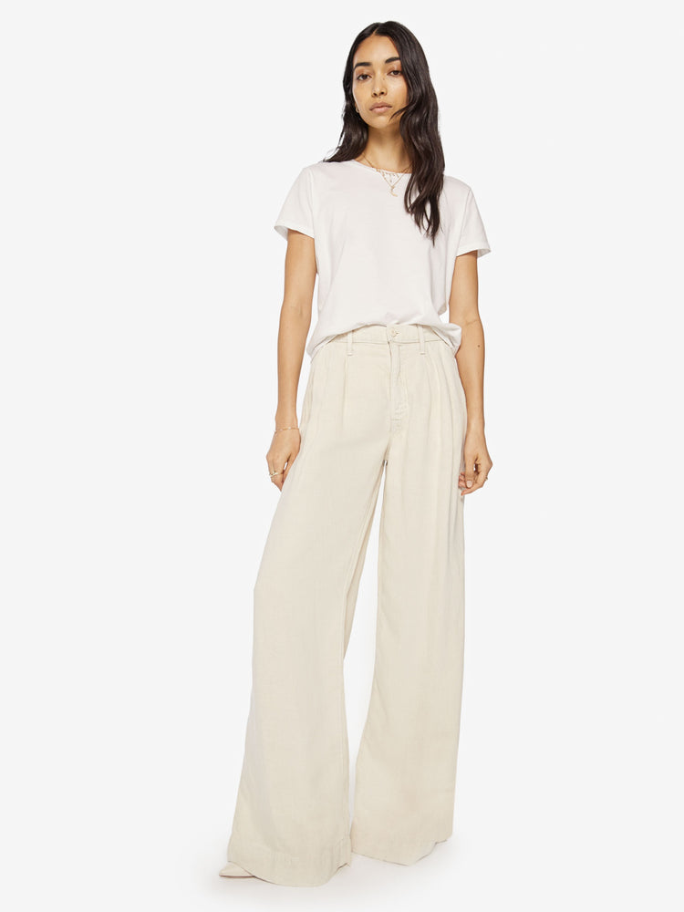 Front view of a woman Super high-waisted wide-leg pants with a long 34-inch inseam that puddles at the hem in a creamy hue.